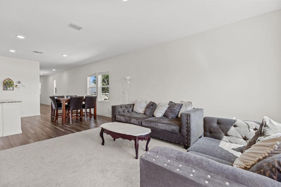 Living area featuring recessed lighting and wood finished floors Living area featuring recessed lighting and wood finished floors