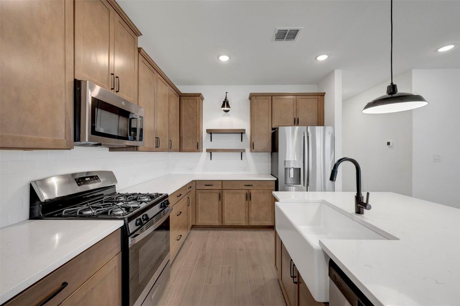 Stylish kitchen with chestnut brown cabinets (*Photo not of actual home and used for illustration purposes only.)
