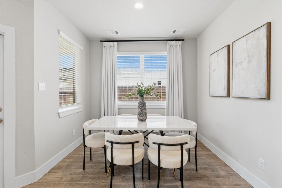 Enjoy everyday dining in a light-filled breakfast nook surrounded by windows, offering peaceful backyard views and abundant natural light.