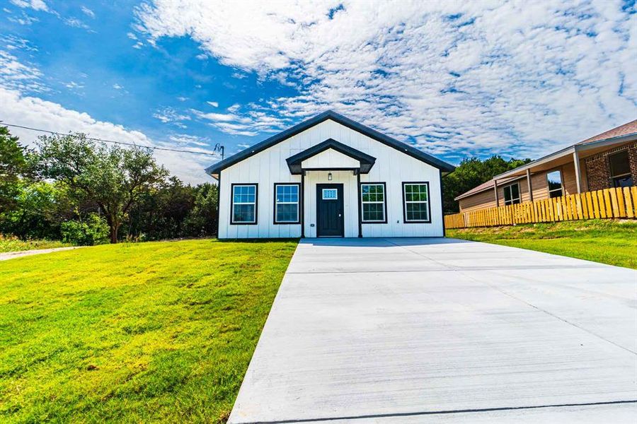 Front exterior of a new home in , Granbury, TX, highlighting curb appeal (Image 17).