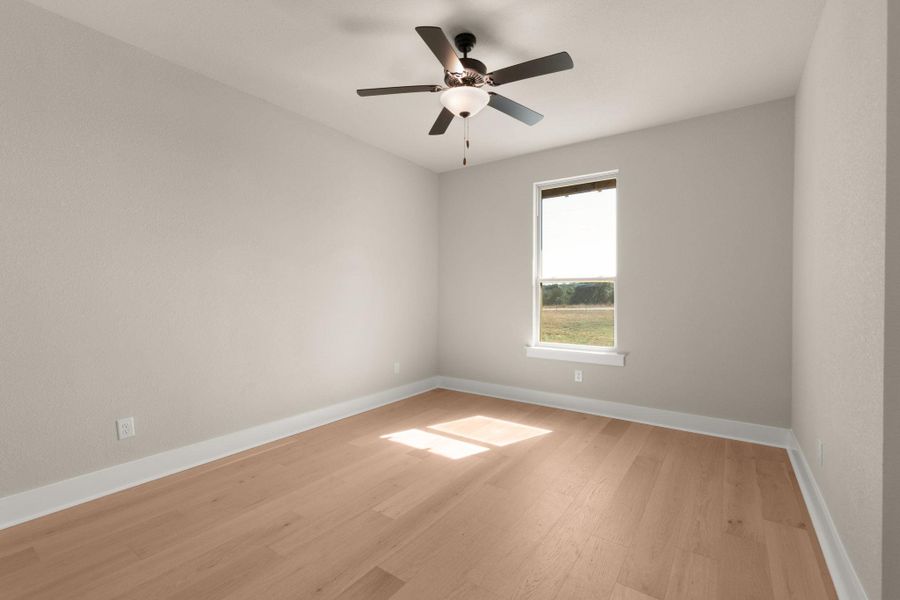 Unfurnished room featuring light wood-style flooring and a ceiling fan