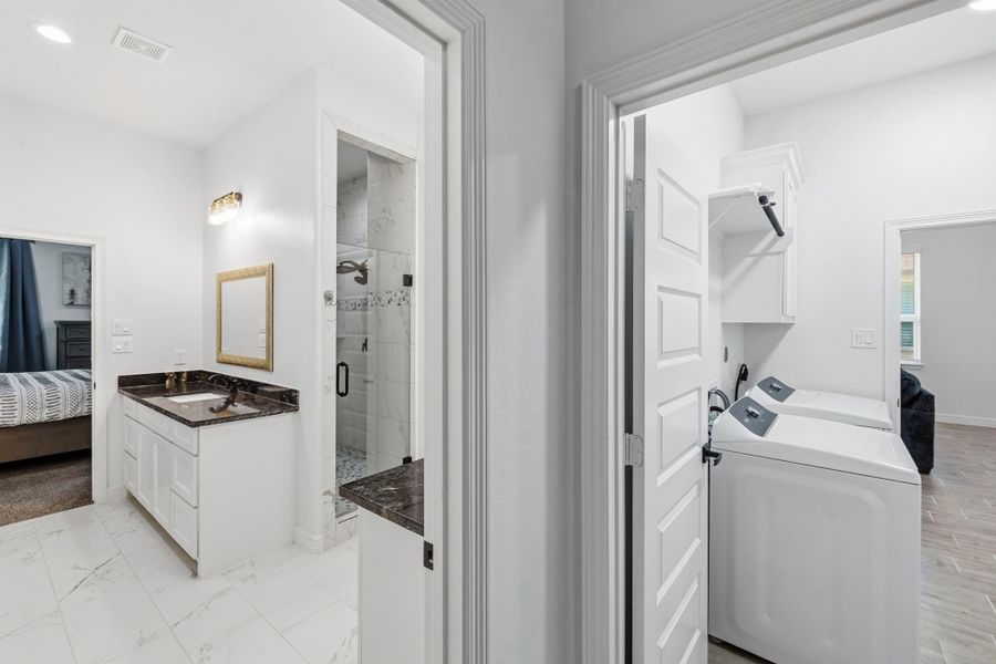 Primary Bathroom connects to laundry