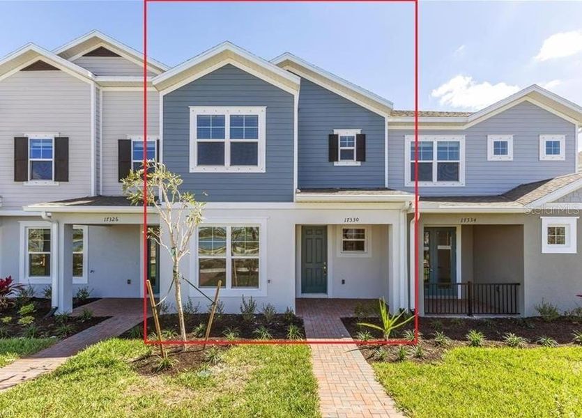 Front exterior of a new home in Townwalk at Babcock Ranch, Punta Gorda, FL, highlighting curb appeal (Image 1).