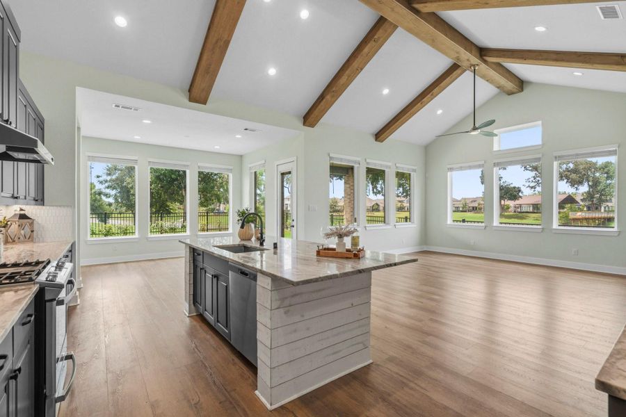 The Kitchen enjoys panoramic views of the lush Backyard and lake beyond, filling the space with natural light. Whether preparing daily meals or entertaining guests, the Kitchen offers timeless finishes, abundant charm, and exceptional practicality.