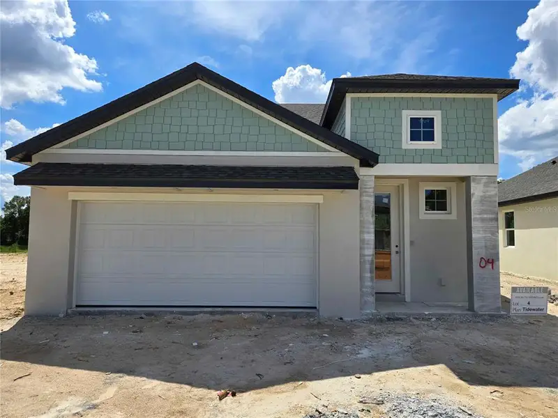 Front exterior of a new home in , Spring Hill, FL, highlighting curb appeal (Image 1).