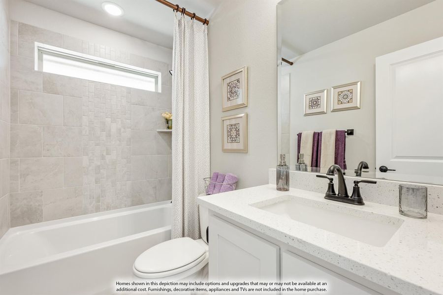 Bathroom with white quartz vanity, tiled tub surround, and shower curtain over soaking tub Bathroom with white quartz vanity, tiled tub surround, and shower curtain over soaking tub