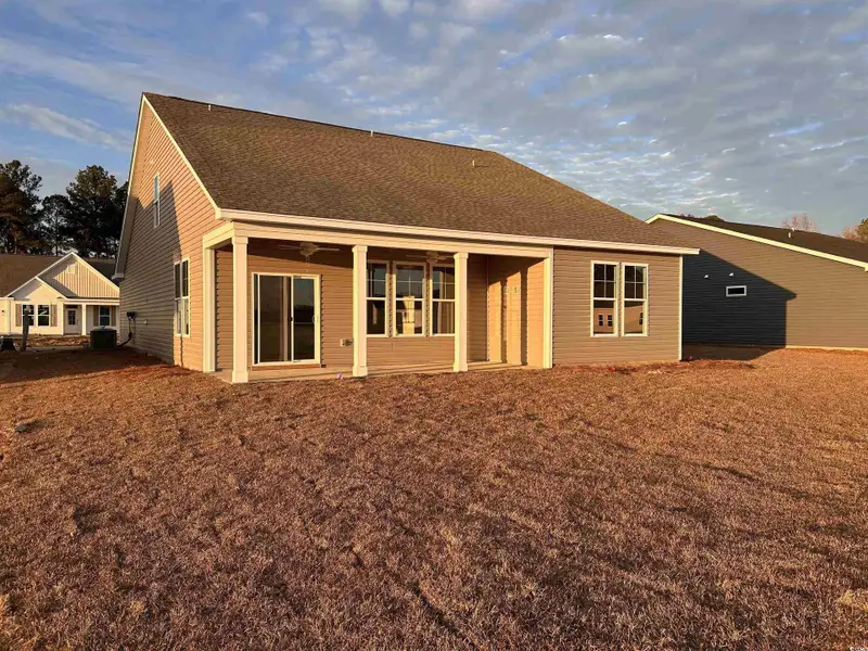 Back of property featuring a shingled roof