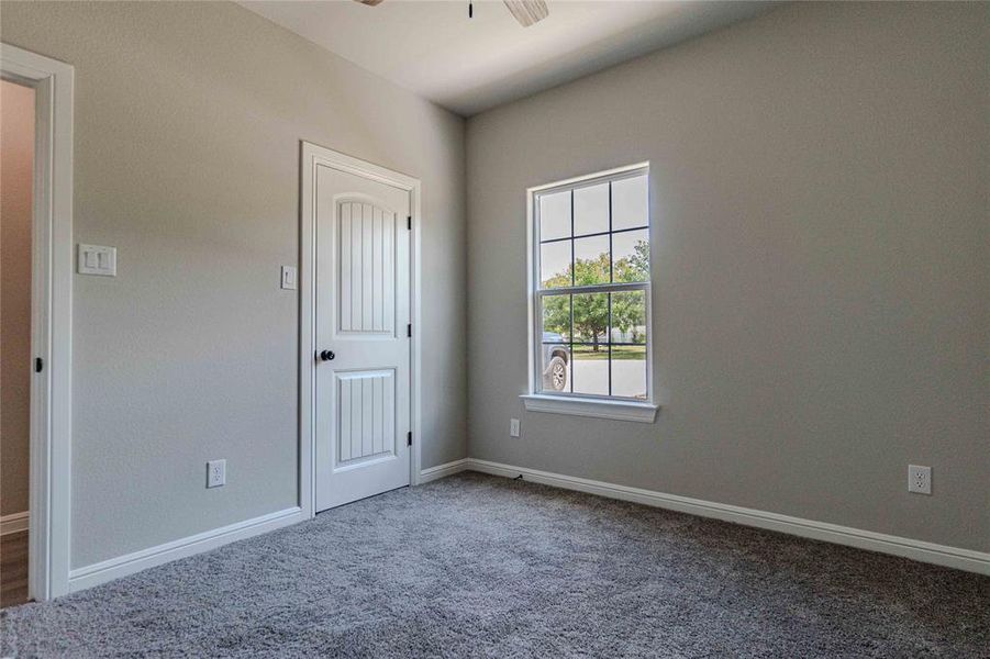 Spare room featuring carpet floors and ceiling fan