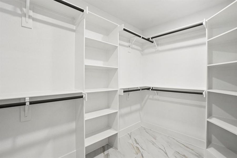 Spacious closet with light marble finish floors Spacious closet with light marble finish floors