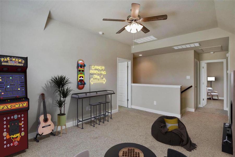 Recreation room featuring carpet and a ceiling fan Recreation room featuring carpet and a ceiling fan