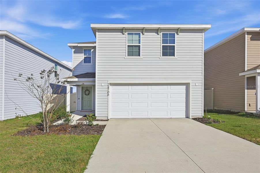 Front exterior of a new home in Avalon Woods, Newberry, FL, highlighting curb appeal (Image 23).