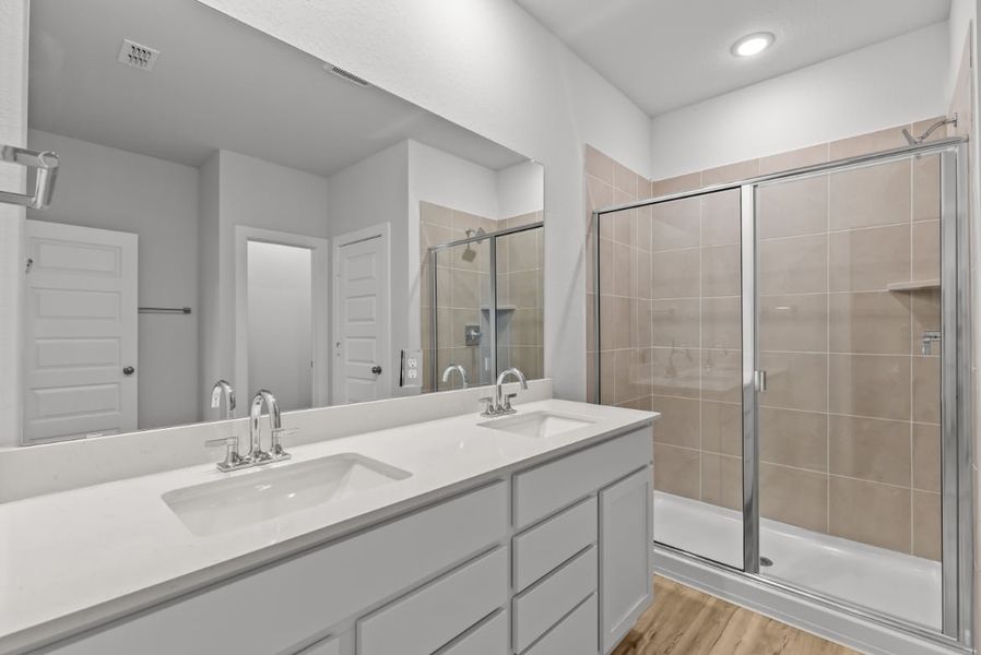 A bathroom with a glass shower. A bathroom with a glass shower.