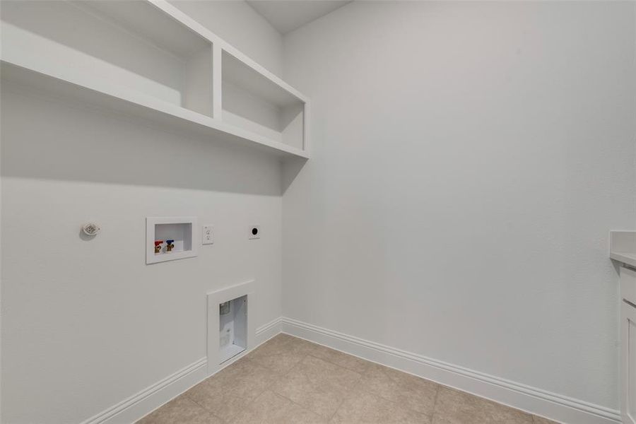 Laundry room with gas dryer hookup, hookup for a washing machine, light tile floors, and hookup for an electric dryer