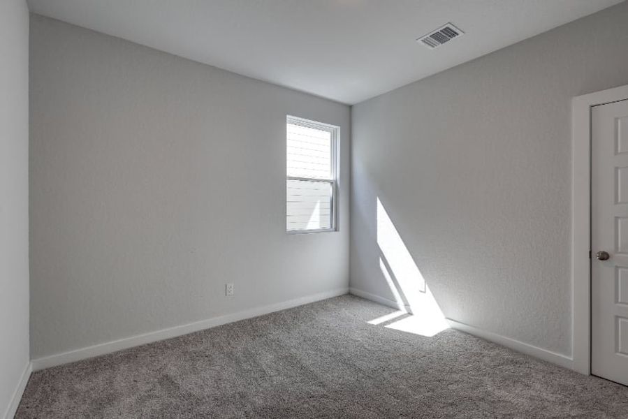 A room with a carpet and a door. A room with a carpet and a door.