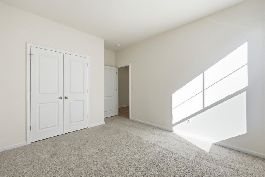 Unfurnished bedroom with carpet flooring and a closet