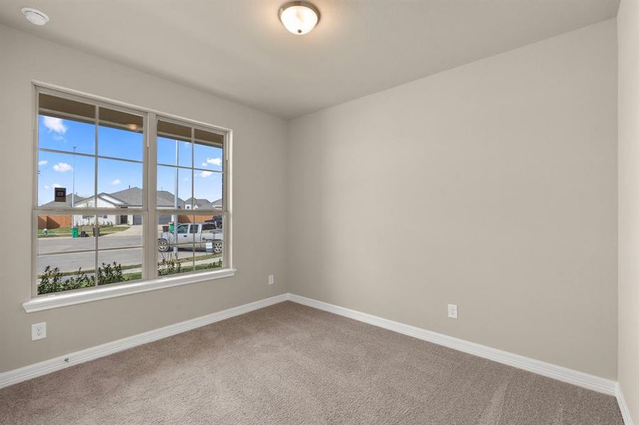 Your secondary bedroom features plush carpet, fresh paint, closet, and a large window that lets in plenty of natural lighting.