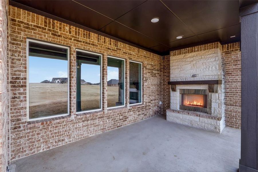 View of patio with a fireplace
