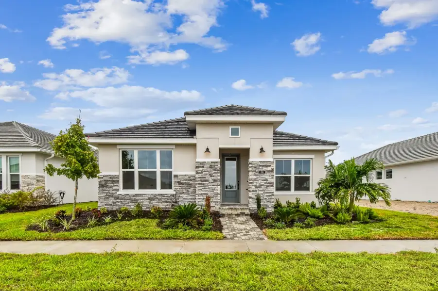 Representative exterior photo of a completed home built from the The Mapleton by David Weekley Homes in Vistera of Venice – Cottage Series, Nokomis, FL (Image 2). Representative exterior photo of a completed home built from the The Mapleton by David Weekley Homes in Vistera of Venice – Cottage Series, Nokomis, FL (Image 2).