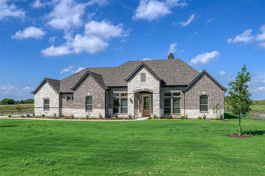Front exterior of a new home in Pioneer Estates, Blue Ridge, TX, highlighting curb appeal (Image 1). Front exterior of a new home in Pioneer Estates, Blue Ridge, TX, highlighting curb appeal (Image 1).