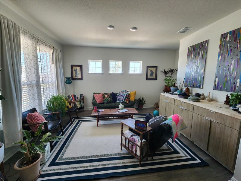 Hardwood floors and natural light illuminate this inviting living space.