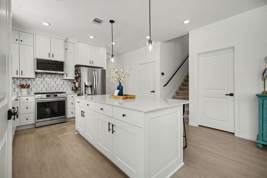 Bright and functional kitchen with extensive cabinet storage, generous workspace, and a seamless flow into the dining and living areas. Bright and functional kitchen with extensive cabinet storage, generous workspace, and a seamless flow into the dining and living areas.