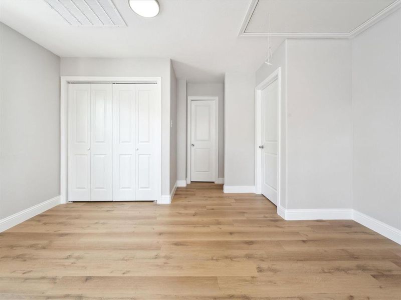 Unfurnished bedroom with a closet and light hardwood / wood-style flooring