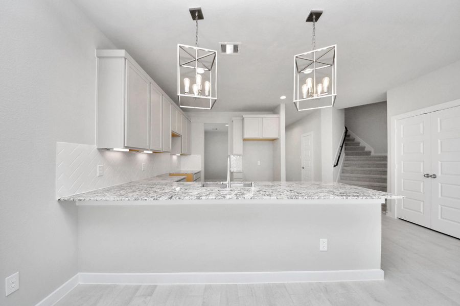 The open concept effortlessly connects the kitchen to the expansive family room, forming a perfect hub for gatherings. This seamless flow creates an inviting space where cooking and socializing come together harmoniously. Sample photo of completed home with similar floor plan. Actual colors and selections may vary.