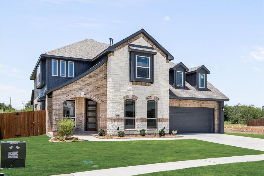 Two-story home with brick and stone exterior, two-car garage, and arched front entry Two-story home with brick and stone exterior, two-car garage, and arched front entry