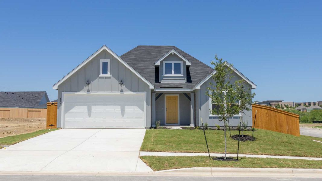 Front exterior of a new home in Trace, San Marcos, TX, highlighting curb appeal (Image 1). Front exterior of a new home in Trace, San Marcos, TX, highlighting curb appeal (Image 1).