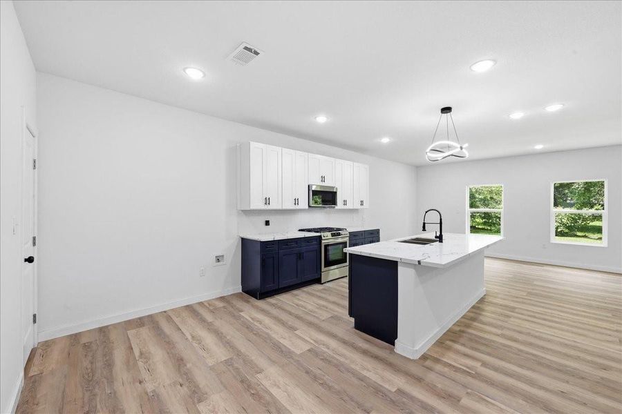 Beautiful kitchen featuring a striking balance of white upper cabinets and deep navy blue lower cabinetry. Beautiful kitchen featuring a striking balance of white upper cabinets and deep navy blue lower cabinetry.