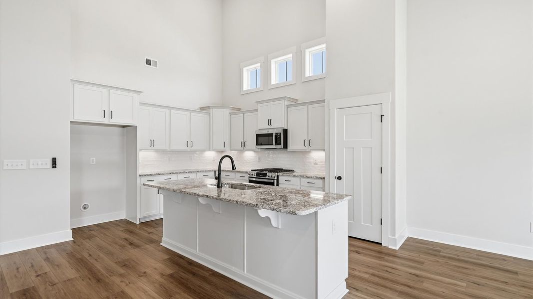 Elegant kitchen featuring a functional island and clean, current styling throughout Elegant kitchen featuring a functional island and clean, current styling throughout