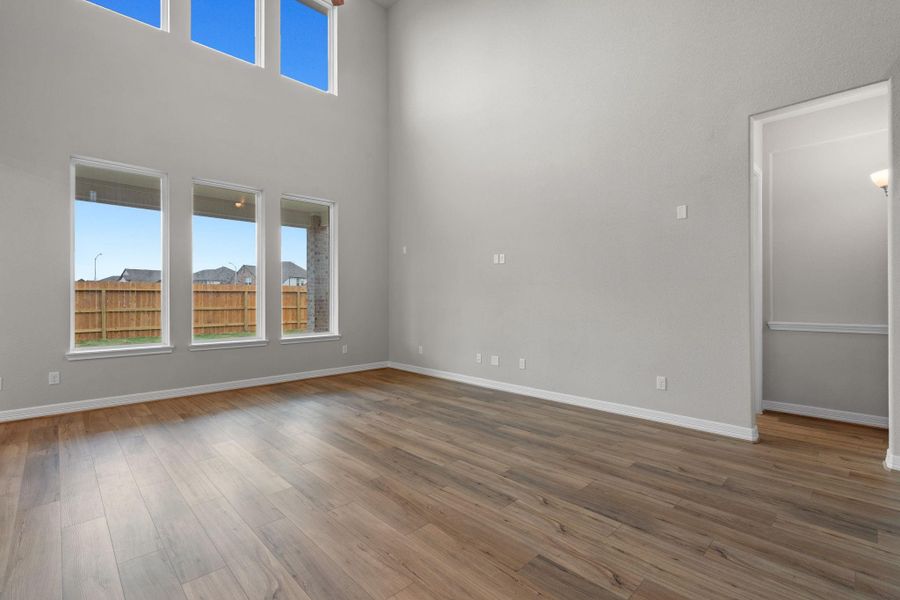 Your family room has ample space to entertain family and friends. This space features beautiful floors, fresh paint, ceiling fan with lighting, and high ceilings.