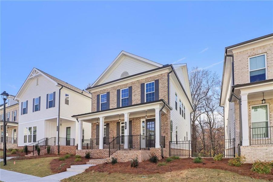 Front exterior of a new home in Brackley Single Family, Cumming, GA, highlighting curb appeal (Image 2). Front exterior of a new home in Brackley Single Family, Cumming, GA, highlighting curb appeal (Image 2).