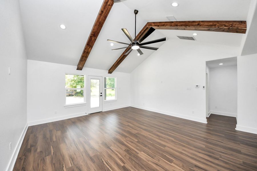 To the right of living room is laundry room and primary bedroom.