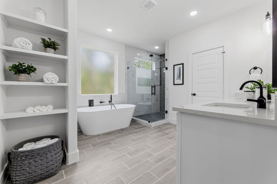 Luxurious bathing quarters with a standalone tub and elegant walk-in shower.