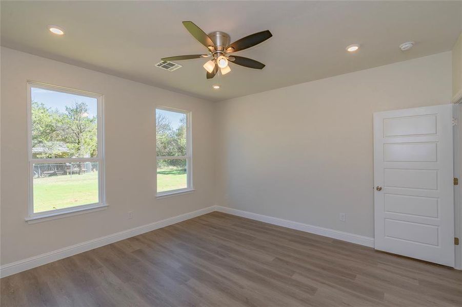 Unfurnished room with hardwood / wood-style flooring and ceiling fan