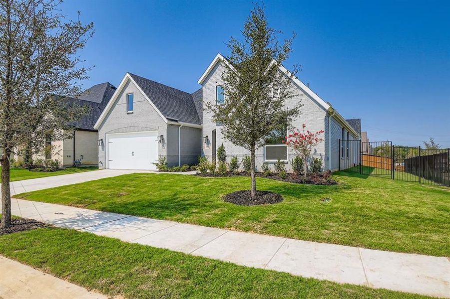 Traditional-style home with a garage, driveway, and brick siding Traditional-style home with a garage, driveway, and brick siding