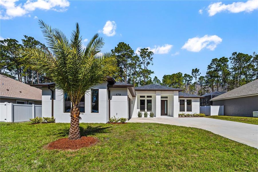 Front exterior of a new home in , Palm Coast, FL, highlighting curb appeal (Image 30). Front exterior of a new home in , Palm Coast, FL, highlighting curb appeal (Image 30).
