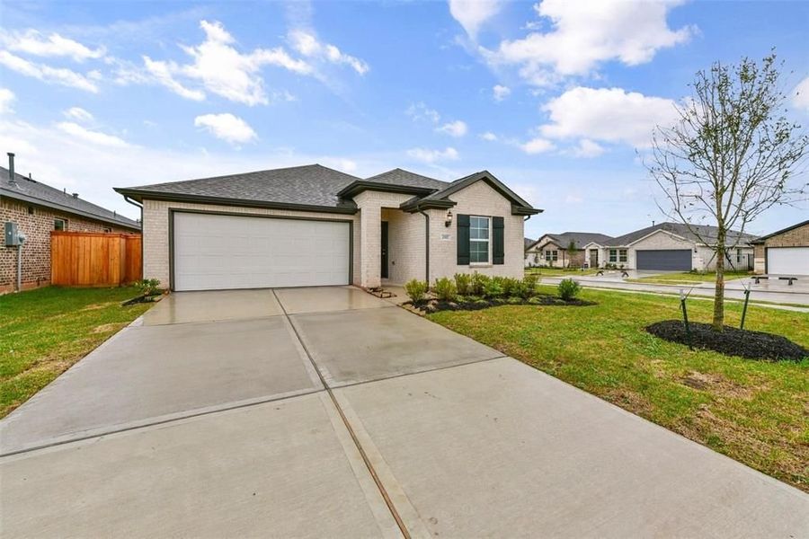 Front exterior of a new home in Sunterra, Katy, TX, highlighting curb appeal (Image 2). Front exterior of a new home in Sunterra, Katy, TX, highlighting curb appeal (Image 2).