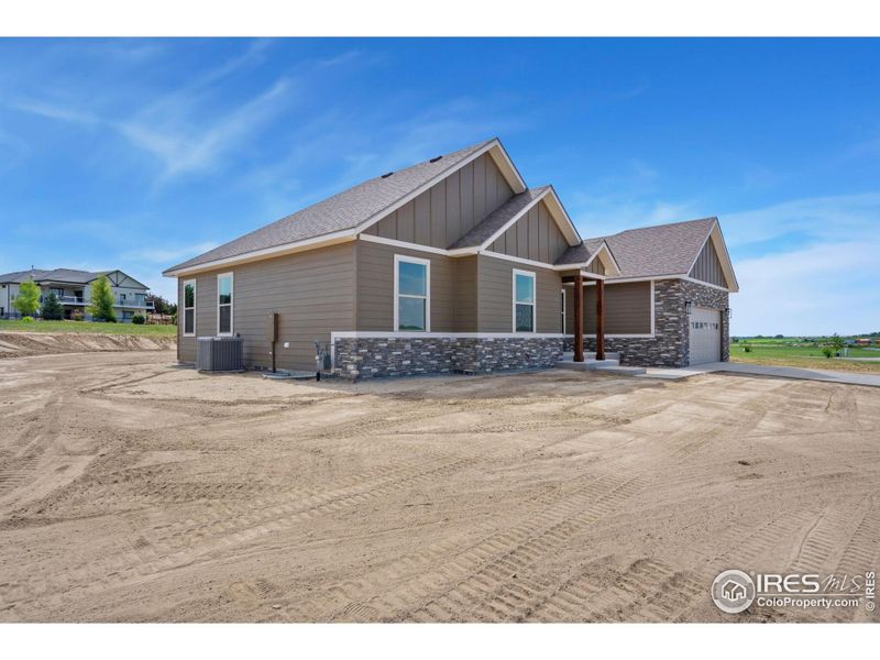 Front exterior of a new home in , Fort Morgan, CO, highlighting curb appeal (Image 1).
