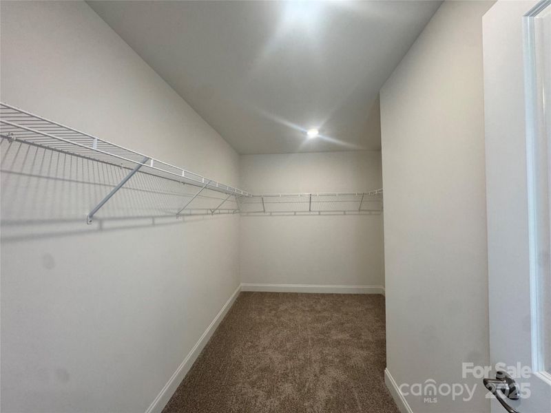 Primary bedroom walk-in closet