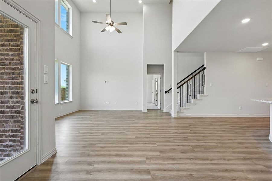 Foyer with light wood-type flooring, healthy amount of natural light, a ceiling fan, a high ceiling, and recessed lighting Foyer with light wood-type flooring, healthy amount of natural light, a ceiling fan, a high ceiling, and recessed lighting