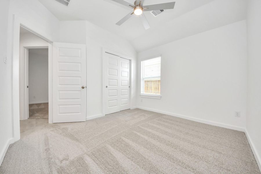 Generously sized secondary bedrooms featuring spacious closets, soft and inviting carpeting underfoot, large windows allowing plenty of natural light, and the added touch of privacy blinds for your personal retreat.