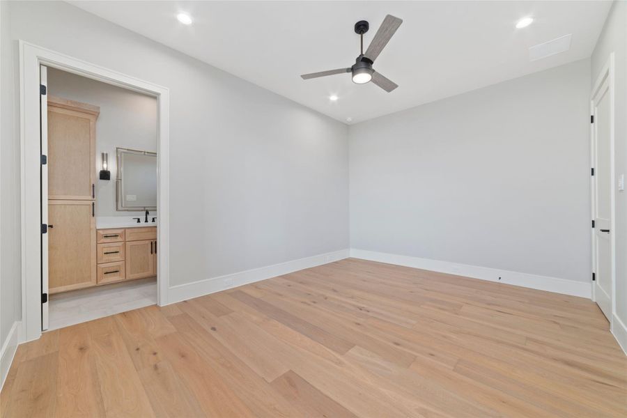 Bright first floor secondary bedroom with wood flooring and spacious en suite.
