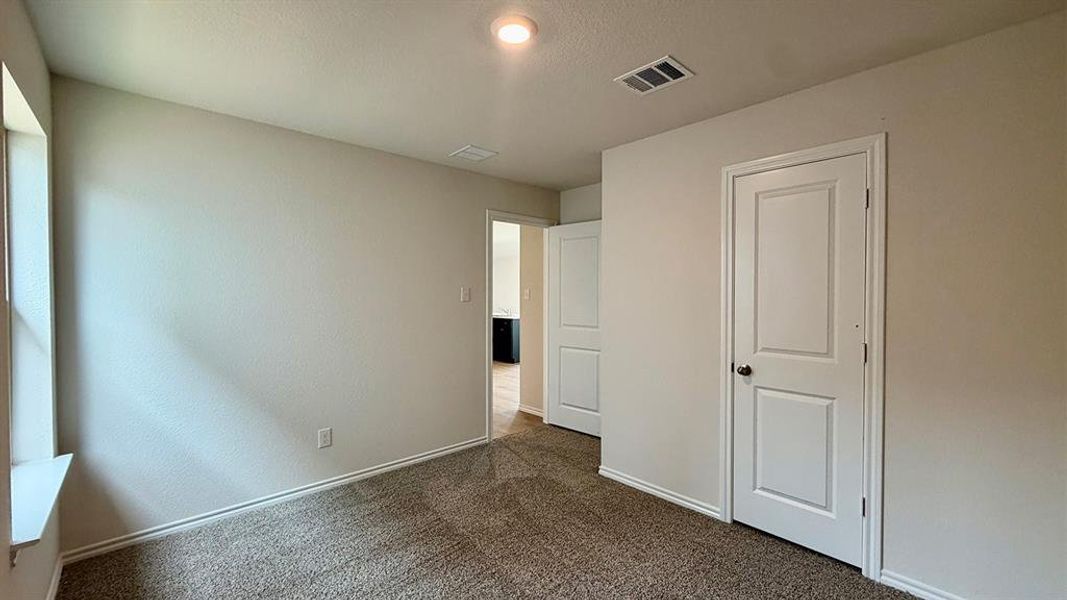 Neutral-toned walls complement plush carpeting