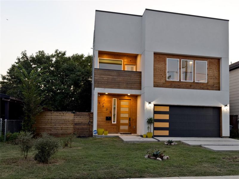 Modern home with a garage and a front lawn