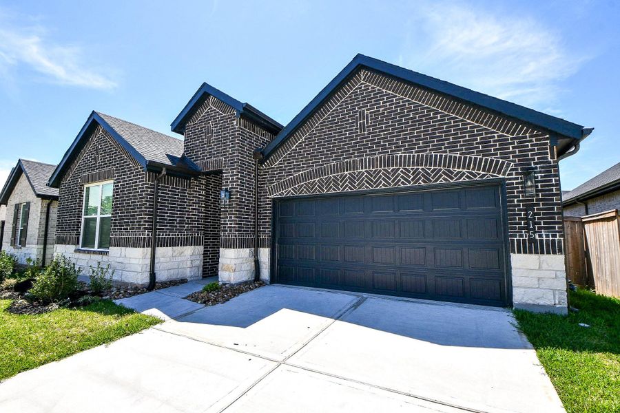 Front exterior of a new home in Hills of Westlake, Conroe, TX, highlighting curb appeal (Image 2). Front exterior of a new home in Hills of Westlake, Conroe, TX, highlighting curb appeal (Image 2).