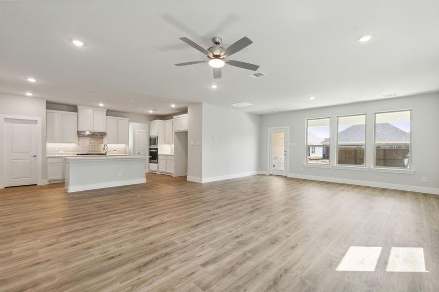 Spare room with ceiling fan and wood-type flooring