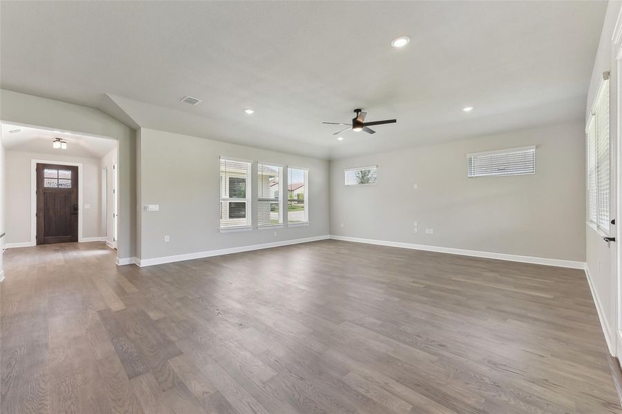Unfurnished living room featuring a ceiling fan, healthy amount of natural light, recessed lighting, and baseboards Unfurnished living room featuring a ceiling fan, healthy amount of natural light, recessed lighting, and baseboards