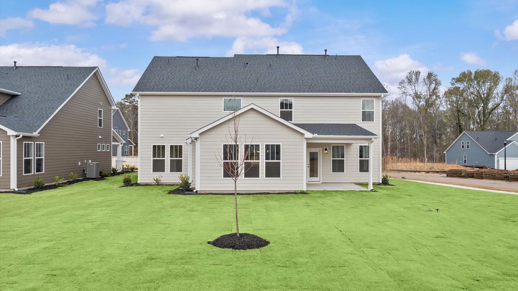 Rear covered porch creates a seamless extension of this home’s elegant design